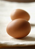 Two Cage Free Organic Brown Eggs on White Linen