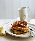 Two Pieces of French Toast with Bacon and Maple Syrup