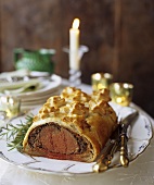 Beef Wellington on a Platter with Carving Utensils