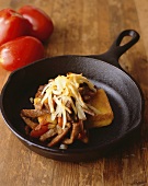 Sauteed Beef Strips and Vegetables Over Cornbread in Skillet