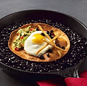Huevos rancheros with black beans, guacamole and a fried egg