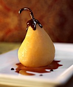 A poached pear with melted chocolate