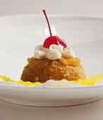 Pineapple Upside Down Cupcake Topped with Whipped Cream and a Cherry