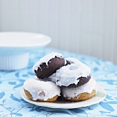Vanilla and Chocolate Glazed Donuts on a White Plate