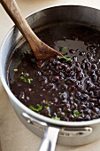 Pot of Black Beans; Wooden Spoon