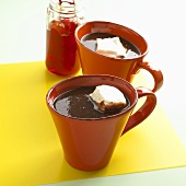 Two Mugs of Hot Chocolate with Marshmallows; Jar of Cherries