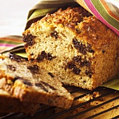 Partially Sliced Homemade Chocolate Chip Banana Bread; On Cooling Rack