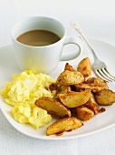 Breakfast of Scrambled Eggs and Fried Potatoes; Cup of Coffee