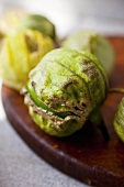 Whole Fresh Tomatillos on Cutting Board