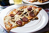 Thin Crust Pepperoni and Mushroom Pizza on a Plate; France