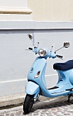 Blue Scooter Parked on Street in France