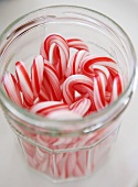 Candy Canes in an Open Glass Jar