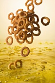 Onion Rings Falling into Oil to Deep Fry
