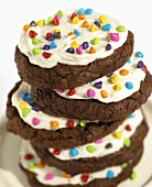 Chocolate Cookies with Vanilla Frosting and Rainbow Sprinkles; Stacked
