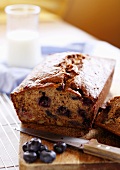 Sliced Banana Blueberry Nut Bread on Cutting Board; Blueberries; Milk