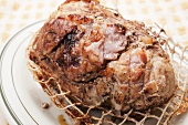 Pork Shoulder Roast with Ties Cut; On a Plate