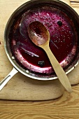 Remains of Blueberry Sauce in a Pan with Wooden Spoon