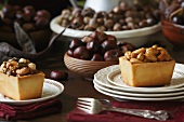 Individual Nut Tarts on Plates; Chestnuts and Acorns