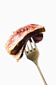Two Slices of Rare Steak Pierced on a Fork