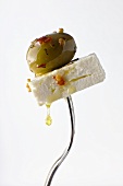 Feta Cheese and Marinated Green Olive Pierced on a Fork