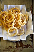 Onion Rings on a Napkin Lines Plate; From Above