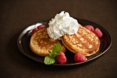 Pancakes with Raspberries and Whipped Cream; Mint Garnish