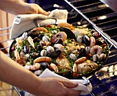 Removing Pan of Paella from the Oven