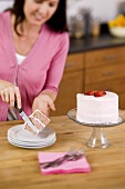 Woman Placing a Slice of Cake on a Plate; In Kitchen