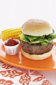 Stuffed Hamburger with Lettuce; Ketchup and Corn on the Cob