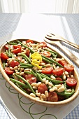 Bean and Tomato Salad in Wooden Serving Bowl; Serving Utensils