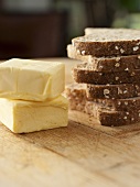 Butter and Stacked Slices of Wheat Bread