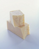Two Pieces of White Cheddar Cheese; Stacked; White Background