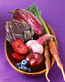 Variety of Fresh Purple Produce in a Wooden Bowl