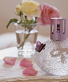 A fragrance lamp and rose petals