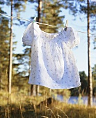 A girl's dress hanging on a washing line