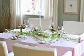 A festively decorated dining table with a flower arrangment