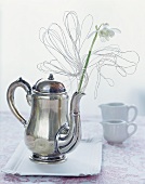 Snowdrops in a teapot decorated with wire