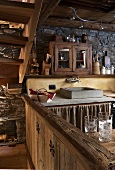 A view into a kitchen of a rustic house with a stone sink