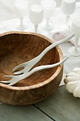A wooden bowl with cutlery