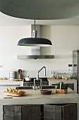 An island counter in a kitchen with a sink