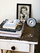 Side table with framed photo and magazines