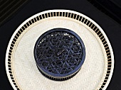 Black basket on a light colored wicker tray and black background