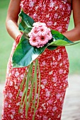 Hand holding a small bunch of gerberas