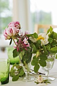 Pink and white flowers in glasses