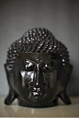 A black wooden Buddha head