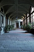 Spacious loggia with a bank of window and stone floor in a villa