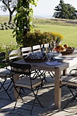 Getting ready to eat -- patio table in a Mediterranean garden