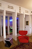 Red upholstered chair and side table in an open living room