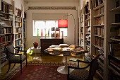 Library with white built-in shelves and antique chairs