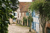 An old village street with half-timbered and red brick houses